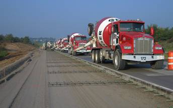 Concrete trucks pouring road