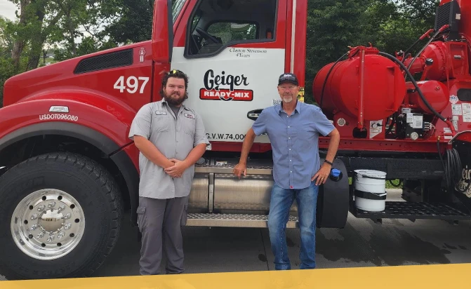 A pair of Geiger employees in front of a Geiger Ready-Mix truck